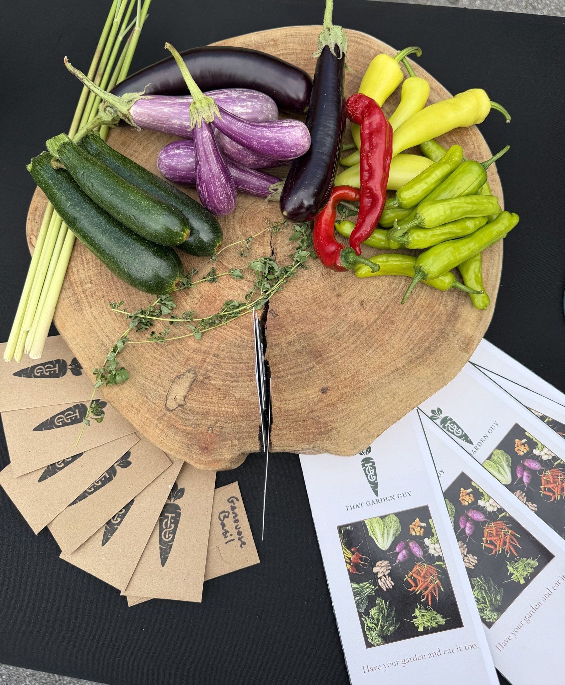 Market table with harvest, seed packets, and trifolds