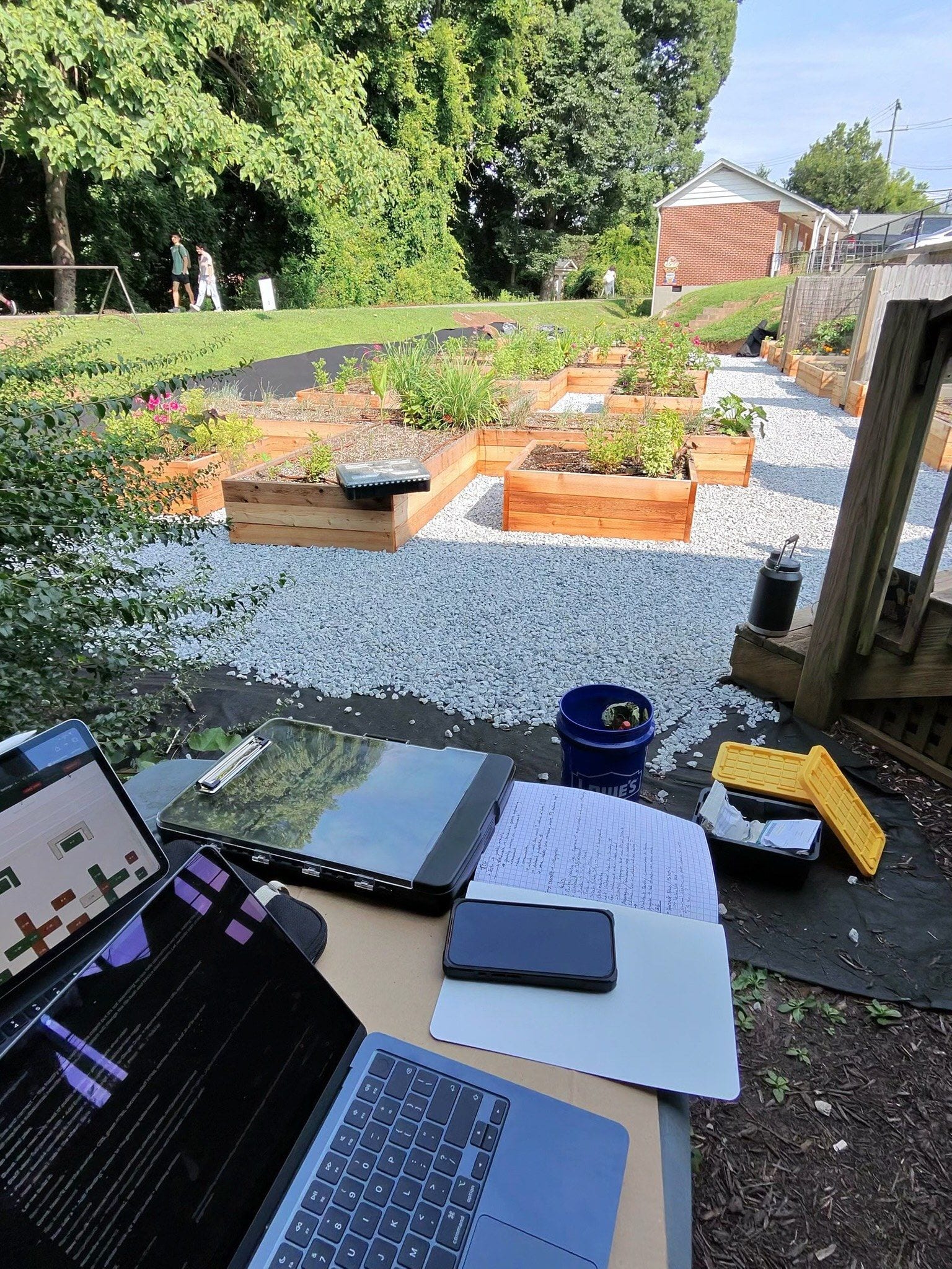 A laptop and an iPad showing the bed map, set up over the beds