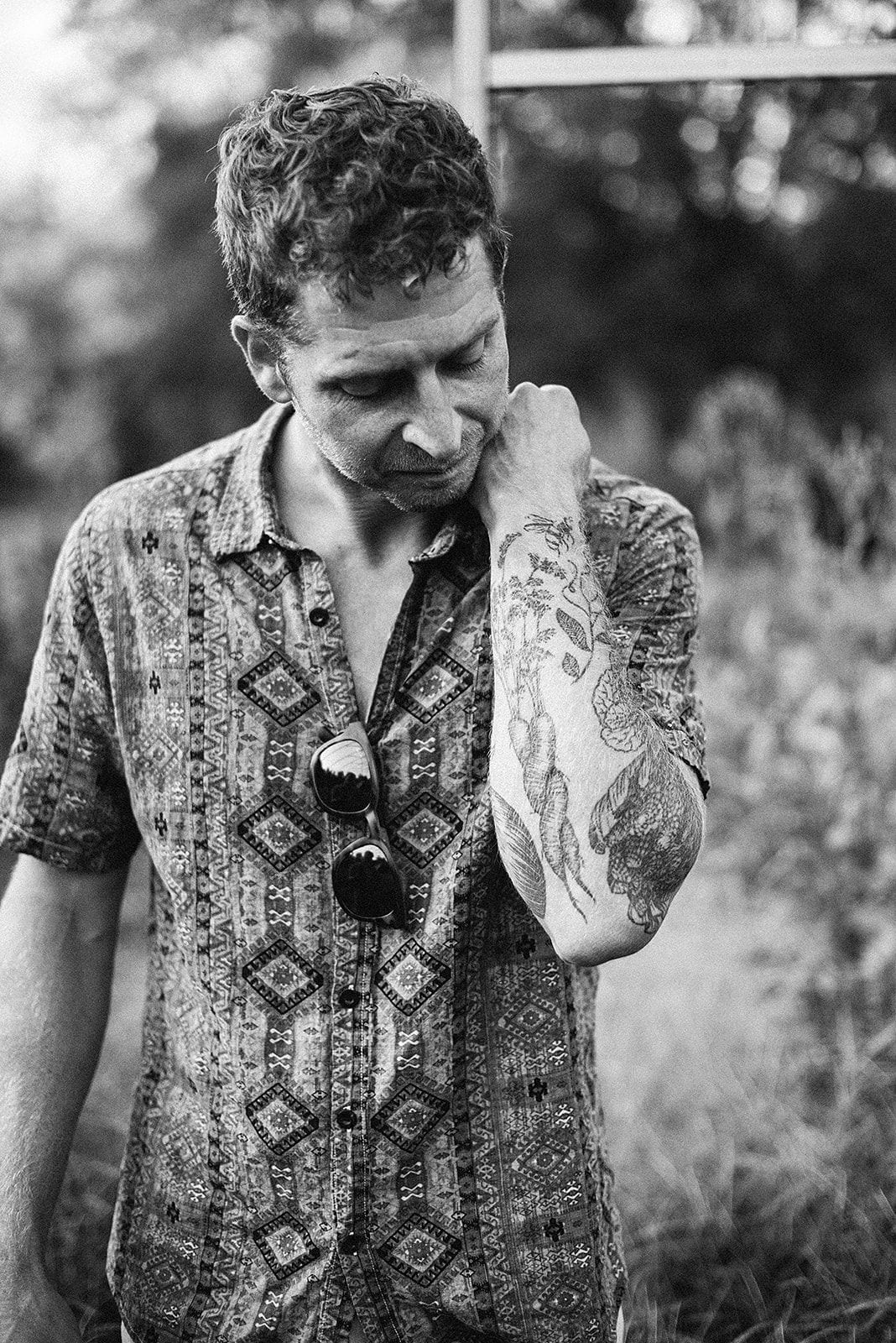 Chris's farm arm: a botanical sleeve of vegetables, a bee and linework, shot in black and white
